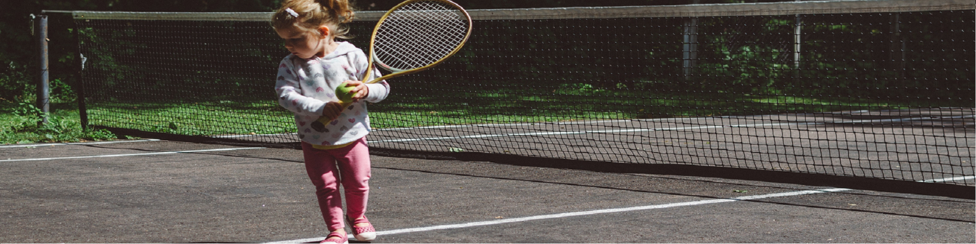 Toddler playing tennis