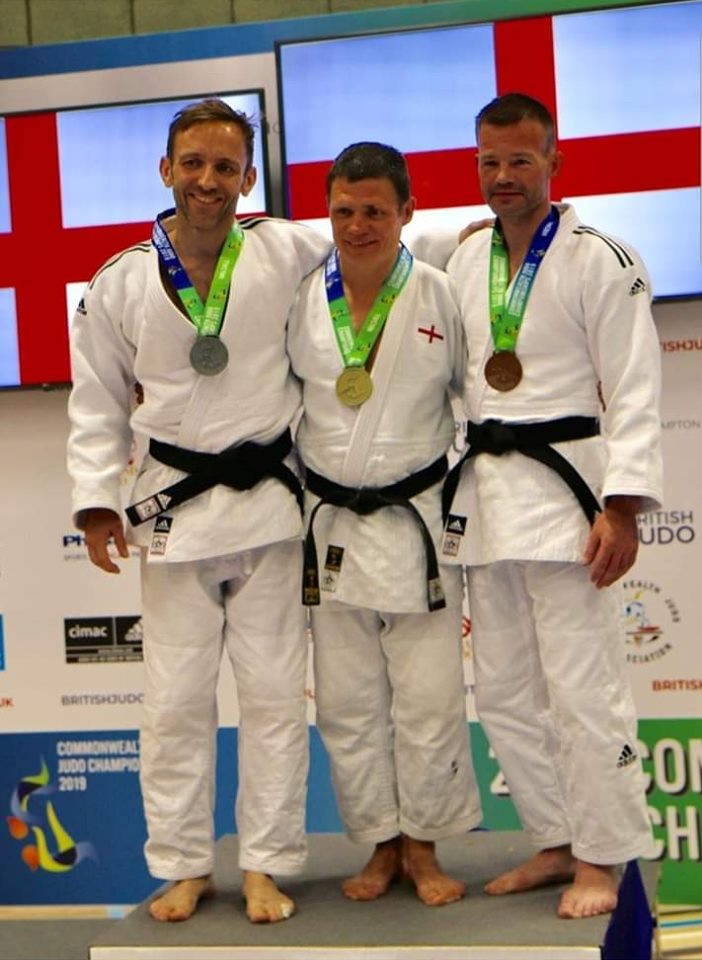 Carl Holland Pictured Centre Winning Gold