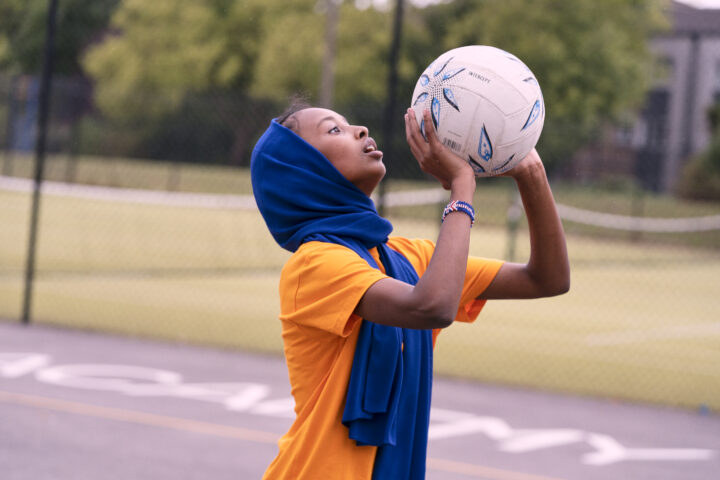 Young person playing netball