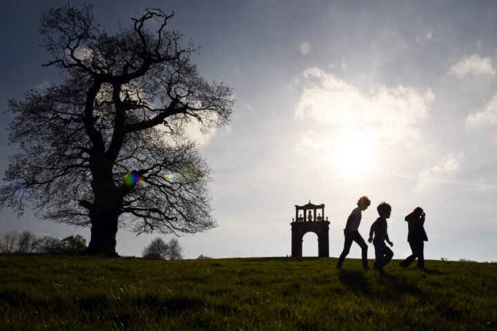 Visitor walking near Hadrian's Arch on the Shugborough Estate