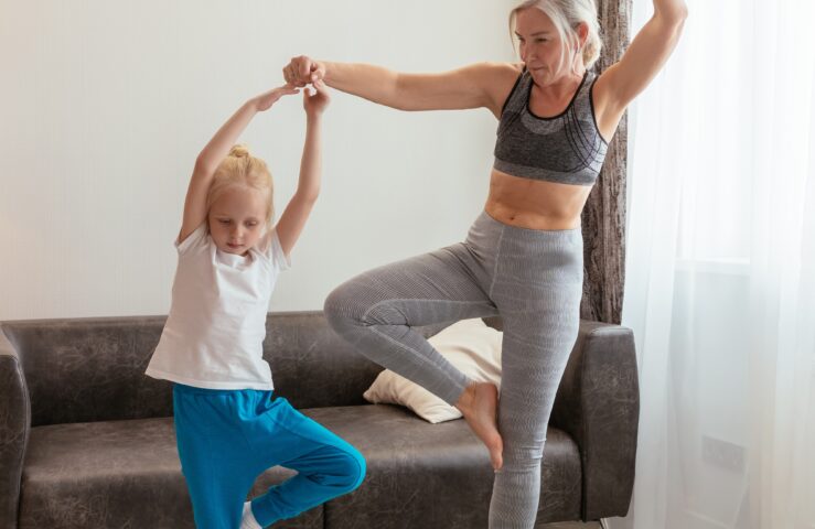 Woman and child doing yoga.