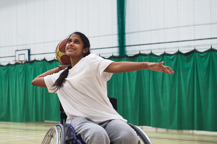 Person using wheelchair playing basketball (image by Sport England)