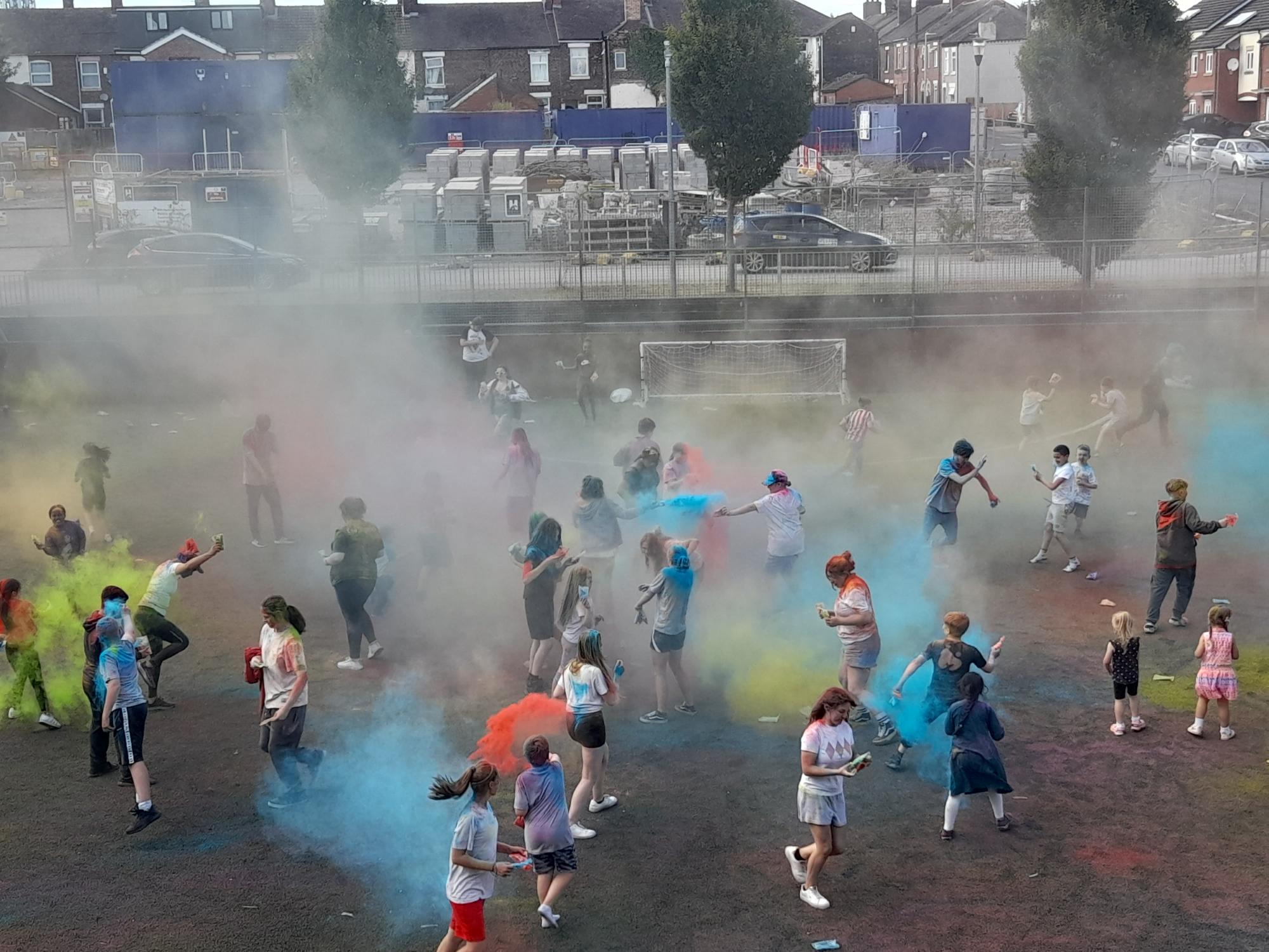 Outdoor paint party on a football pitch.
