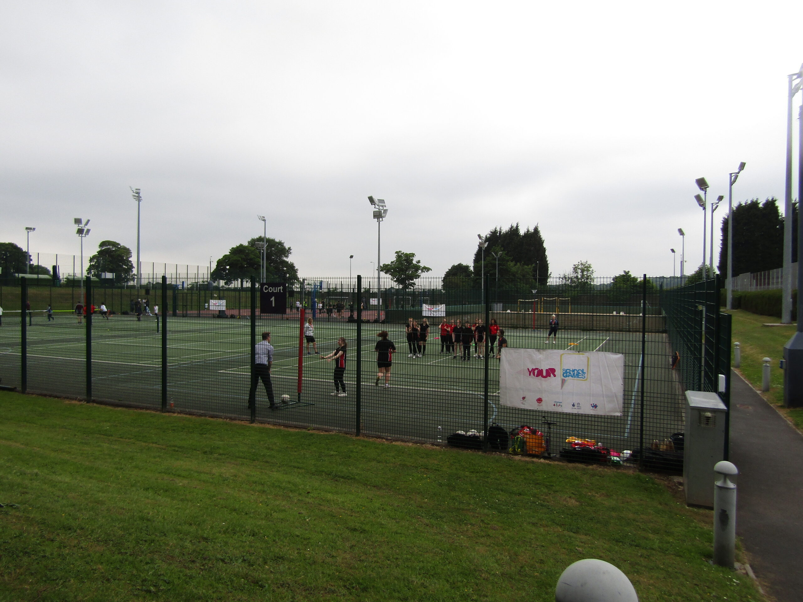 Students playing netball on outdoor court.