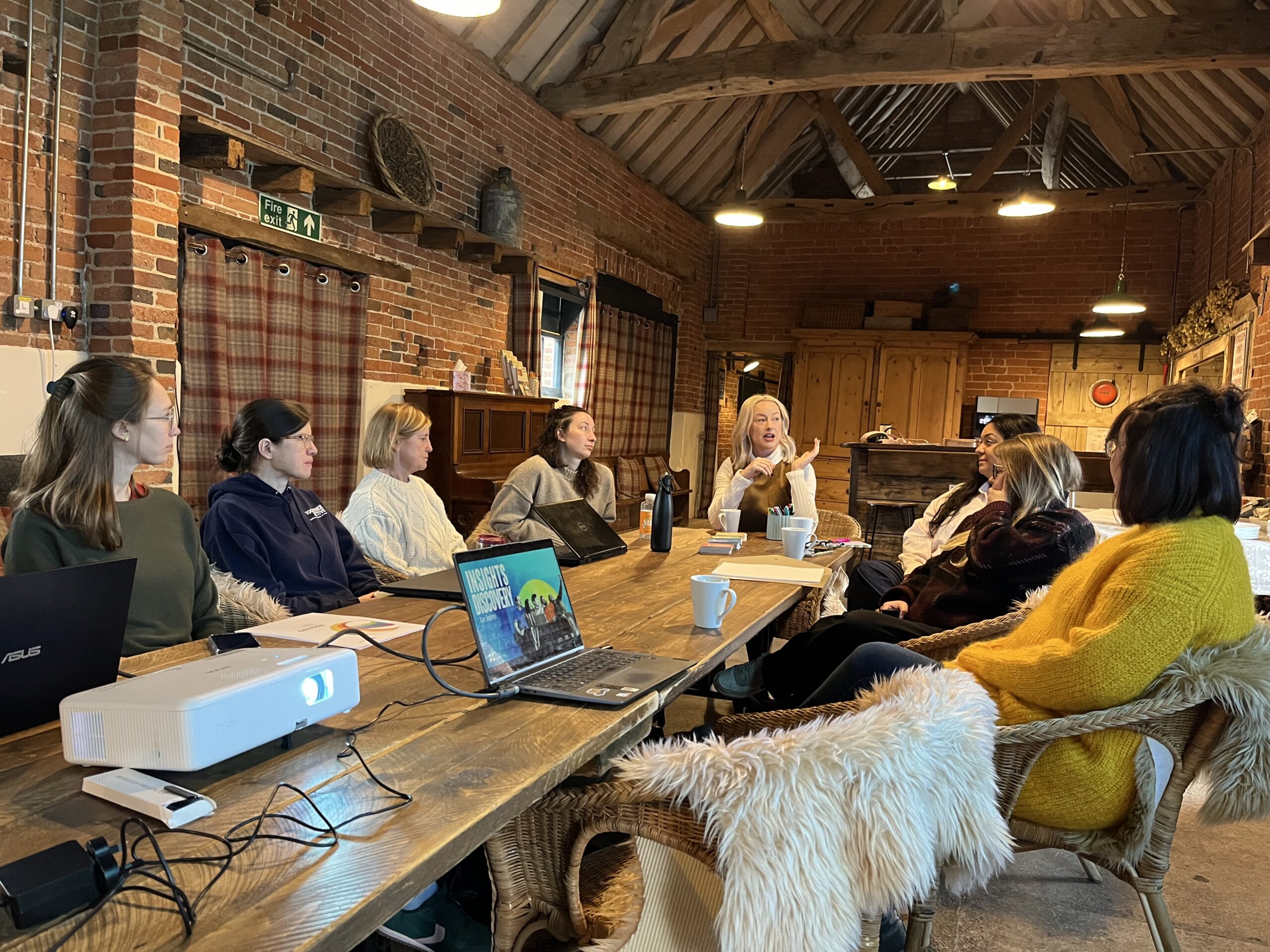 Image shows the Together Active team sat around a large table in group discussion.