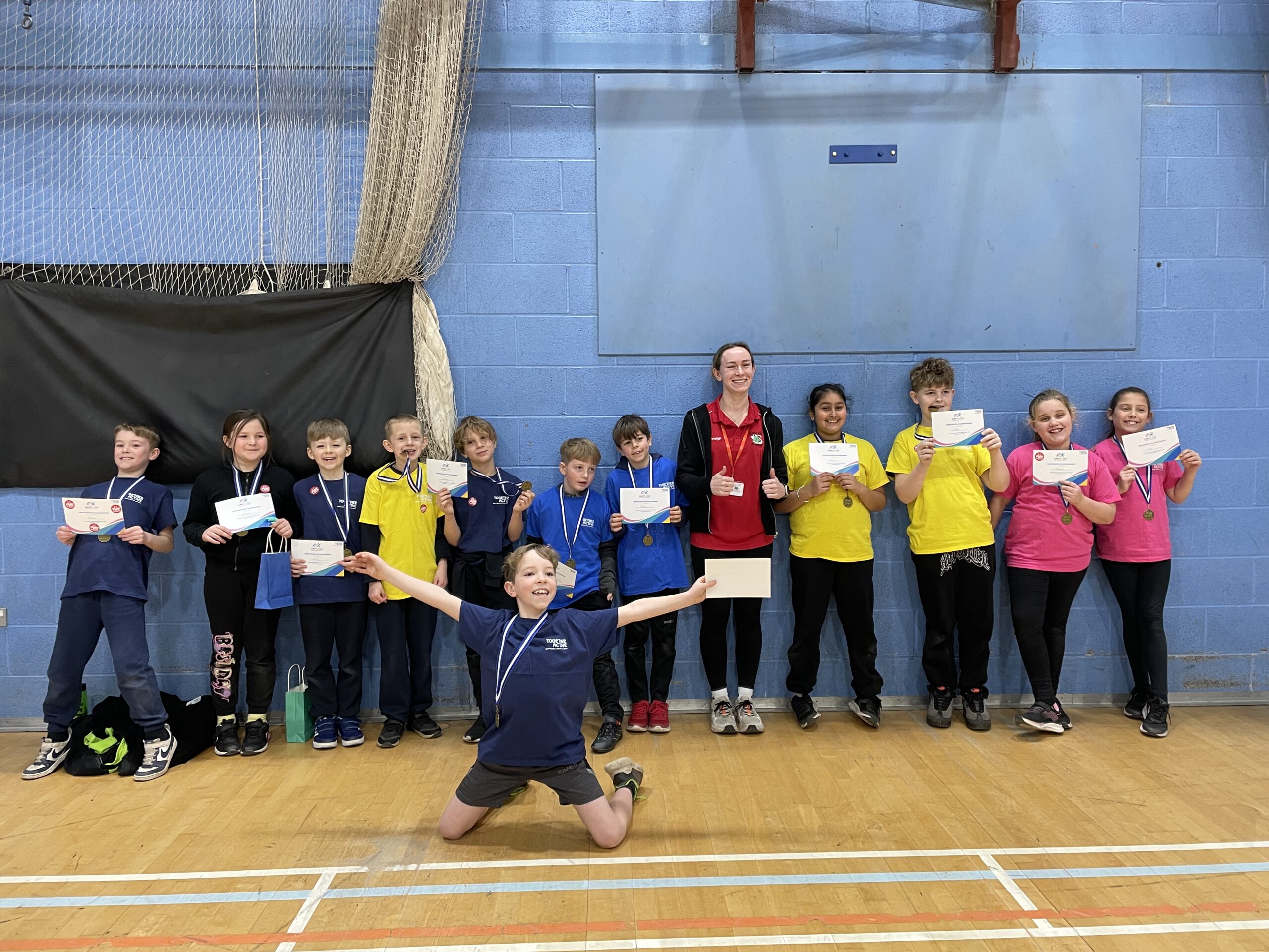 Image shows group of young people holding certificates from a Boccia tournament.