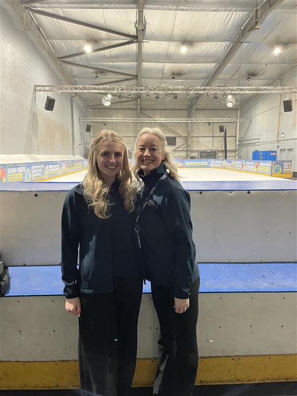 Image shows two women stood in front of an ice rink
