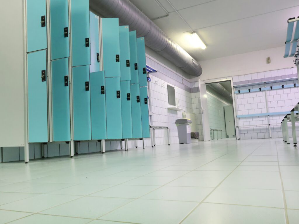 Image shows an empty leisure centre changing rooms with open lockers